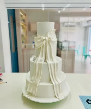 Bolo de casamento elegante com laço de efeito tecido em acabamento artesanal da Alegra Cakes em Florianópolis